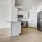 living room open to kitchen with pendant lights over open counter
