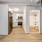 well lit, full bathroom next to kitchen