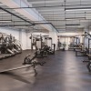 spacious fitness center with ample lighting throughout and various cardio and strength training equipment