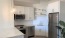 corner kitchen space with open countertop and pendant lights