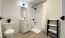furnished bathroom with shower/tub combo and herringbone tiling